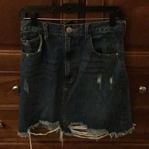 NWT denim skirt with rips and frayed bottom. Pockets. Zipper close